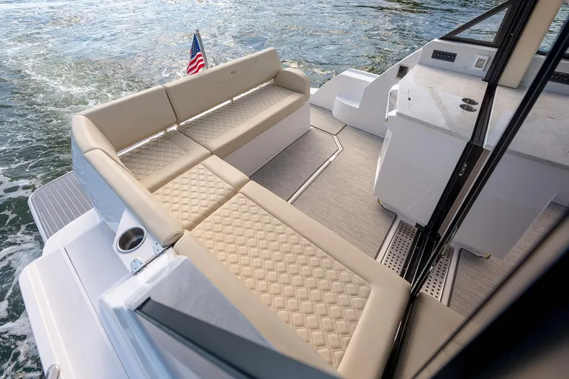 Slide: The Image of Manufacturer Provided Image: Luxurious seating on 2026 Regal 38 Grande Coupe yacht with elegant diamond-pattern upholstery. - 16