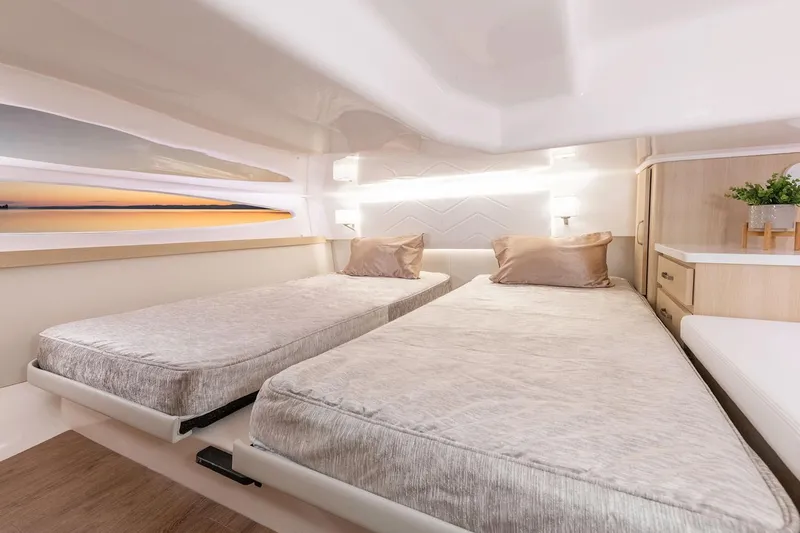Slide: The Image of Manufacturer Provided Image: Luxurious interior of 2026 Regal 38 Grande Coupe with twin beds and modern decor. - 21
