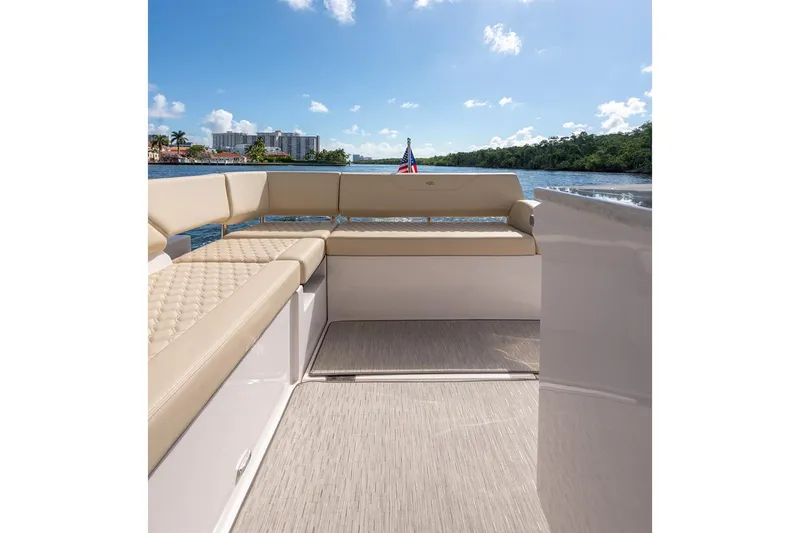 Slide: The Image of Manufacturer Provided Image: 2026 Regal 38 Grande Coupe boat interior with beige seating, overlooking scenic waterway. - 15