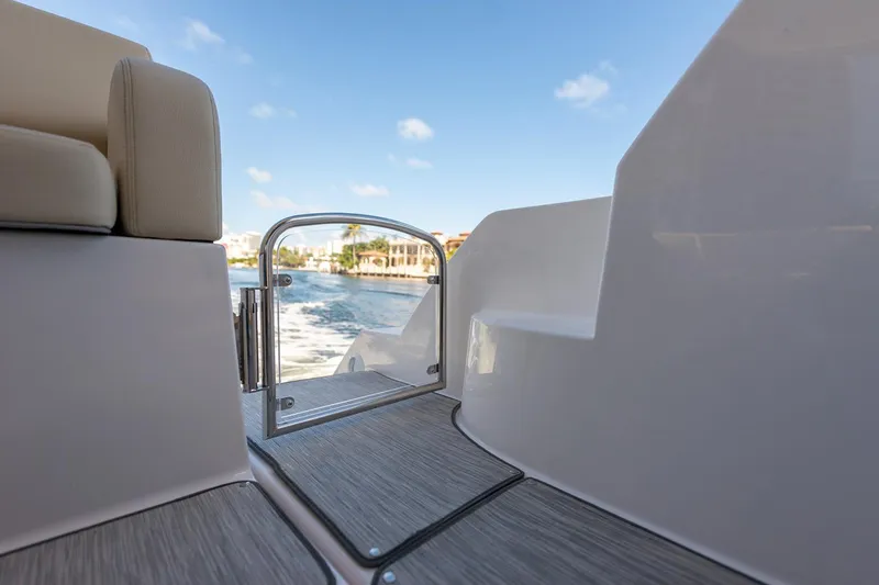 Slide: The Image of Manufacturer Provided Image: 2026 Regal 38 Grande Coupe yacht deck with ocean view and clear sky. - 17