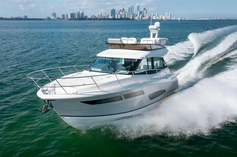 The Image of Manufacturer Provided Image: 2026 Regal 38 Fly yacht cruising on open water with city skyline in background. - 0
