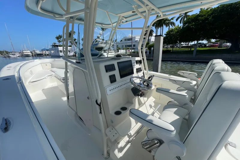 Slide: The Image of 2004 Hydra-Sports Vector 3300 CC boat interior with helm, seating, and marina view. - 20