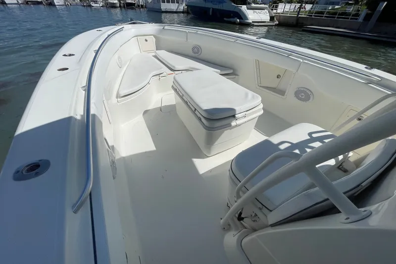 Slide: The Image of 2004 Hydra-Sports Vector 3300 CC boat interior with seating and storage, docked by the water. - 26