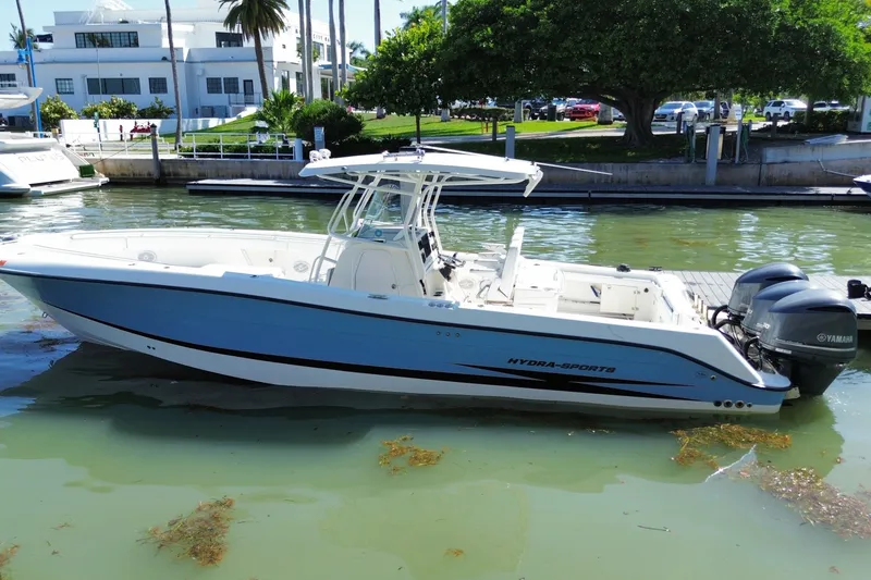Slide: The Image of 2004 Hydra-Sports Vector 3300 CC boat docked in a marina with twin Yamaha engines. - 13