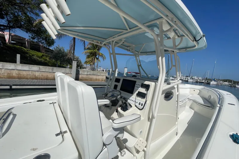 Slide: The Image of 2004 Hydra-Sports Vector 3300 CC boat interior with helm and seating, docked at marina. - 19