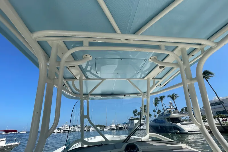 Slide: The Image of 2004 Hydra-Sports Vector 3300 CC boat with T-top, docked in a marina under clear blue skies. - 25