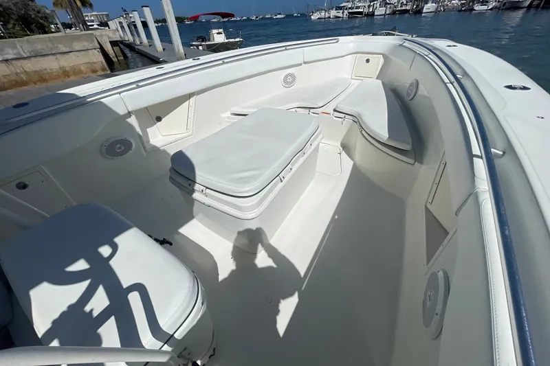Slide: The Image of 2004 Hydra-Sports Vector 3300 CC boat interior with seating and storage, docked by the water. - 27