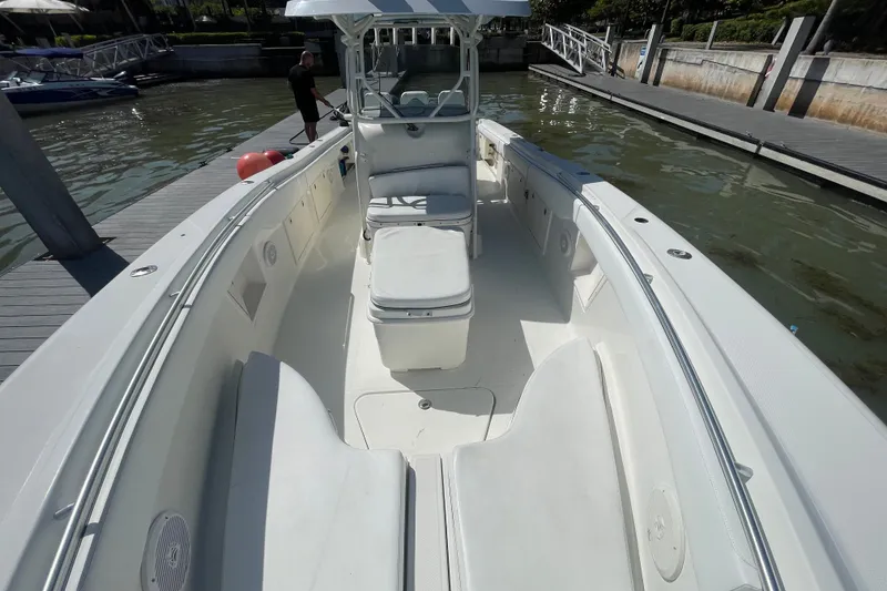 Slide: The Image of 2004 Hydra-Sports Vector 3300 CC boat interior at dock, showcasing seating and helm. - 32