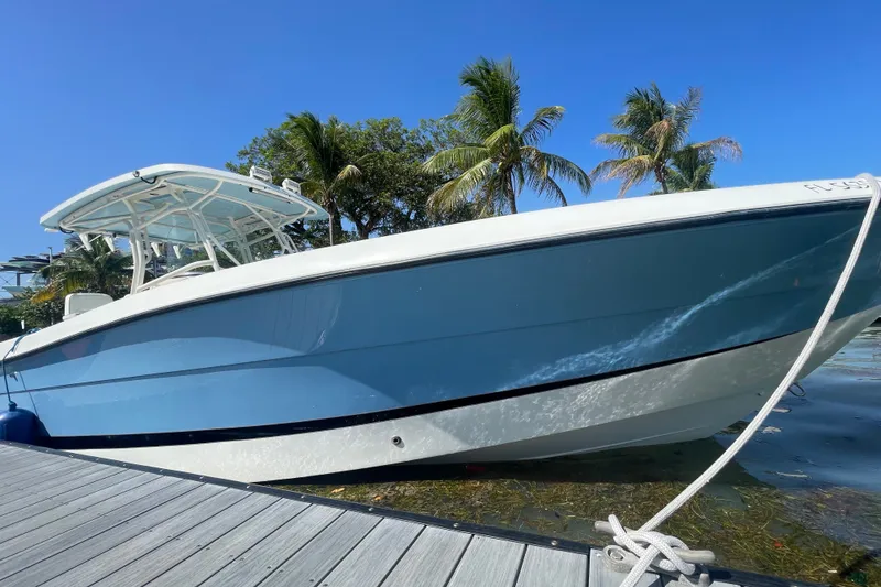 Slide: The Image of 2004 Hydra-Sports Vector 3300 CC boat docked, with palm trees in the background. - 15