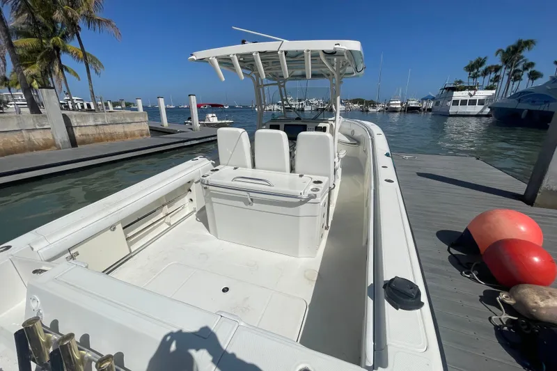 Slide: The Image of 2004 Hydra-Sports Vector 3300 CC boat docked at marina under clear blue sky. - 16