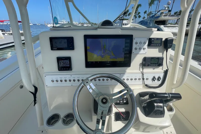 Slide: The Image of 2004 Hydra-Sports Vector 3300 CC helm with navigation equipment and controls at marina. - 22