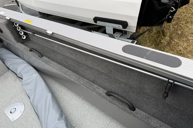 Slide: The Image of 2026 Crestliner 1850 Commander boat interior with rod holders and storage compartment. - 14