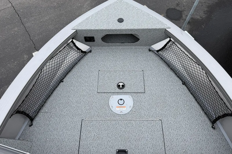 Slide: The Image of 2026 Crestliner 1850 Commander boat deck with storage compartments and netting. - 5