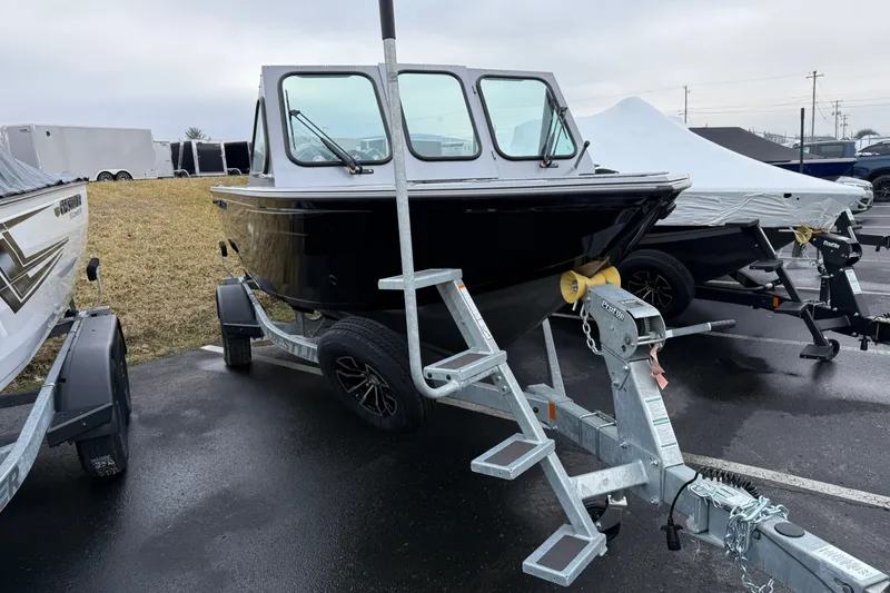 Slide: The Image of 2026 Crestliner 1850 Commander boat on trailer in parking lot. - 2