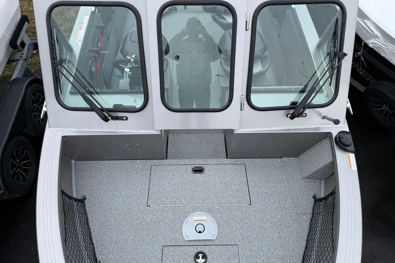Slide: The Image of 2026 Crestliner 1850 Commander boat interior with spacious deck and windshield view. - 8