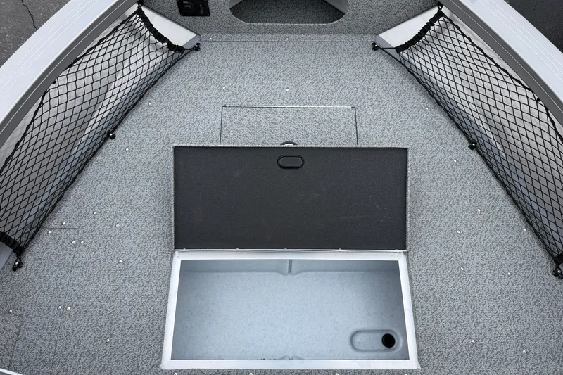 Slide: The Image of 2026 Crestliner 1850 Commander boat interior with open storage compartment and netted side pockets. - 7