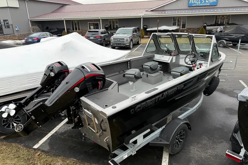 Slide: The Image of 2026 Crestliner 1850 Commander boat with dual outboard motors in a parking lot. - 3