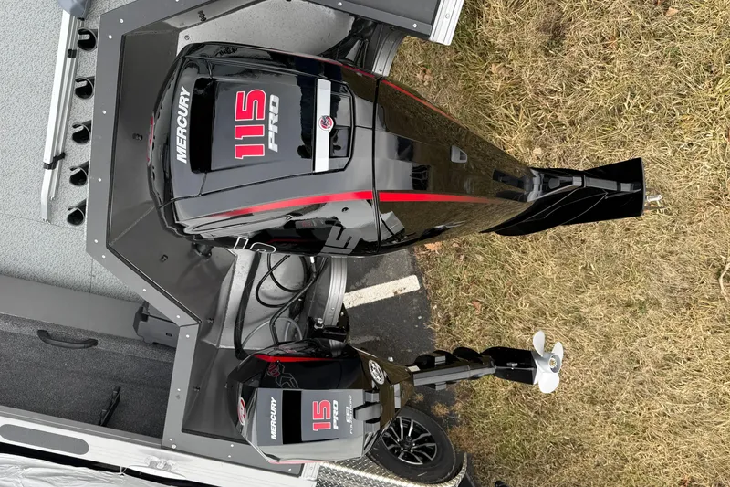 Slide: The Image of Crestliner 1850 Commander 2026 with Mercury 115 Pro outboard motor, parked on grass. - 16