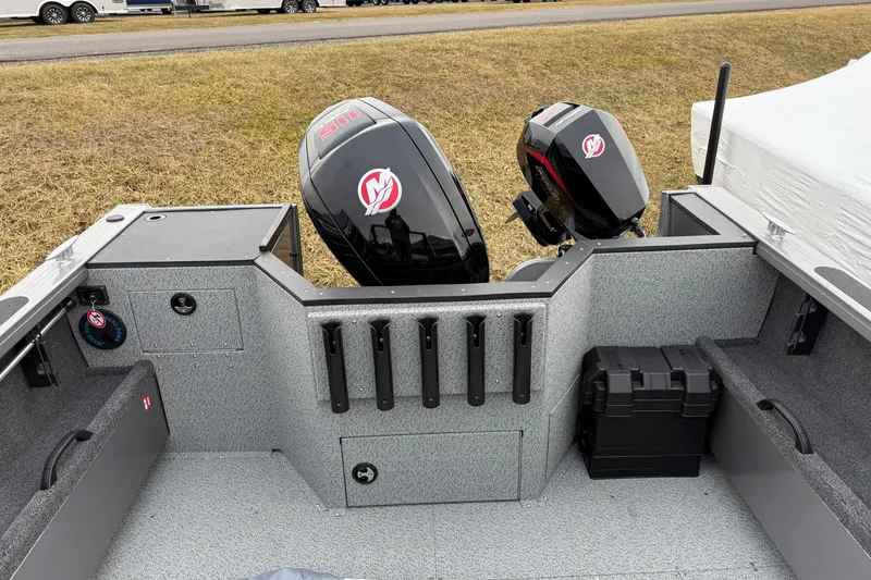 Slide: The Image of 2026 Crestliner 1850 Commander boat interior with dual outboard motors and storage compartments. - 12