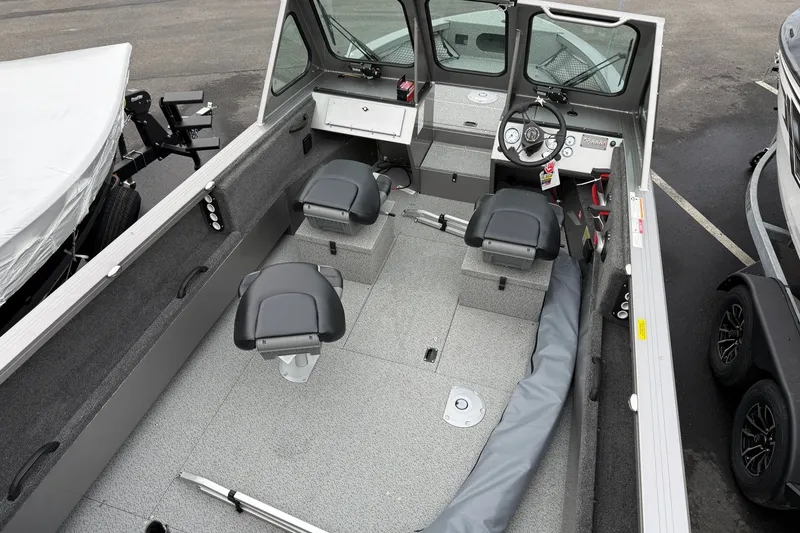 Slide: The Image of 2026 Crestliner 1850 Commander boat interior with seating and steering console. - 4
