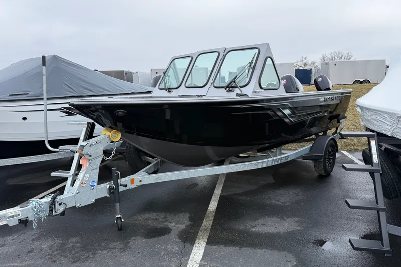 Slide: The Image of 2026 Crestliner 1850 Commander boat on trailer in parking lot. - 1