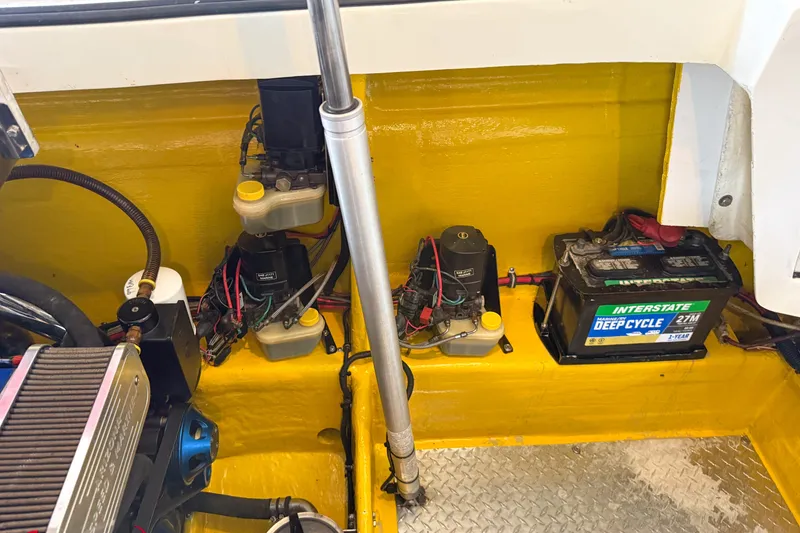 Slide: The Image of Engine compartment of a 2000 Sonic 45 SS boat with battery and components. - 36