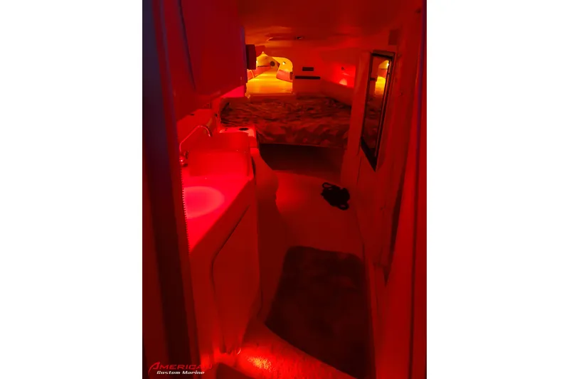 Slide: The Image of Interior of 2000 Sonic 45 SS boat with red ambient lighting and cozy sleeping area. - 6