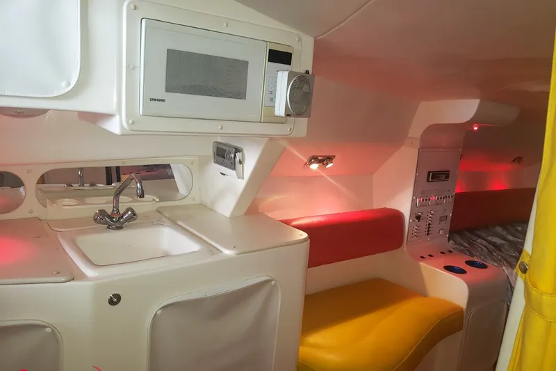 Slide: The Image of Interior of a 2000 Sonic 45 SS boat with kitchenette and seating area. - 5