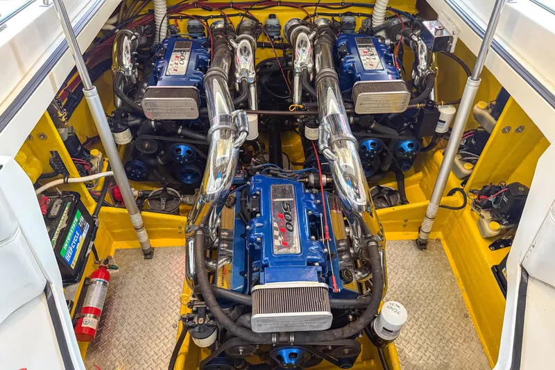 Slide: The Image of Engine compartment of a 2000 Sonic 45 SS boat with dual engines and vibrant yellow interior. - 38