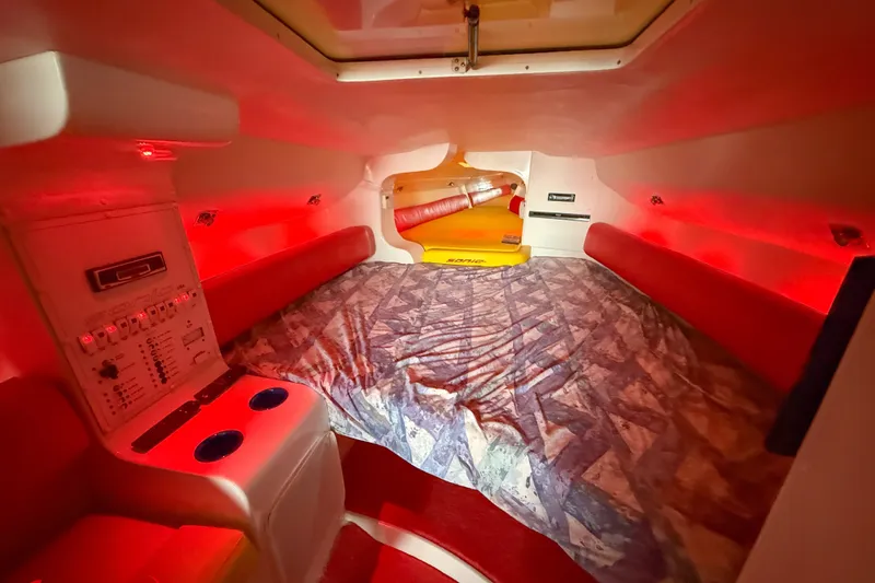 Slide: The Image of Cozy cabin interior of 2000 Sonic 45 SS boat with red lighting and control panel. - 17