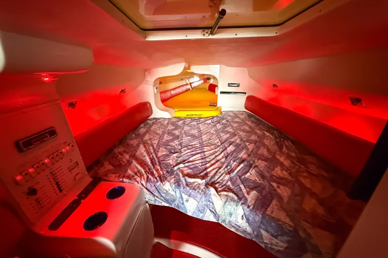 Slide: The Image of Interior cabin of 2000 Sonic 45 SS boat with red lighting and patterned bedding. - 18