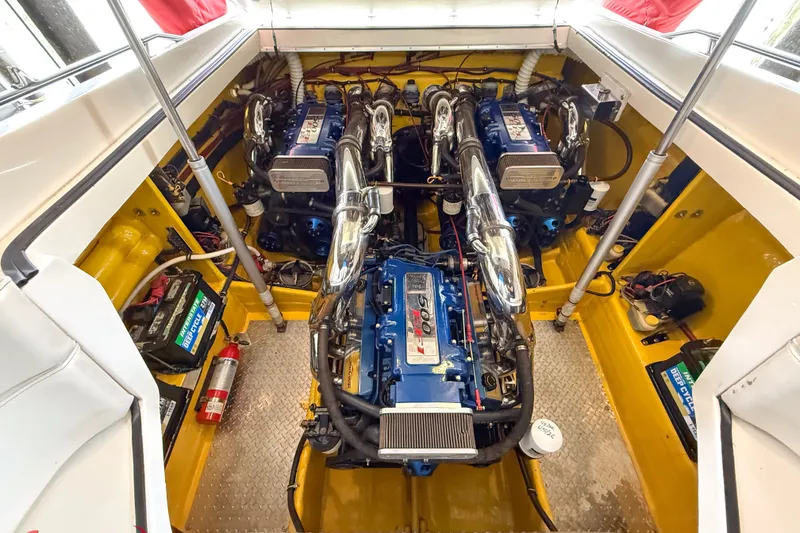 Slide: The Image of Engine compartment of a 2000 Sonic 45 SS boat with dual engines and vibrant yellow interior. - 37