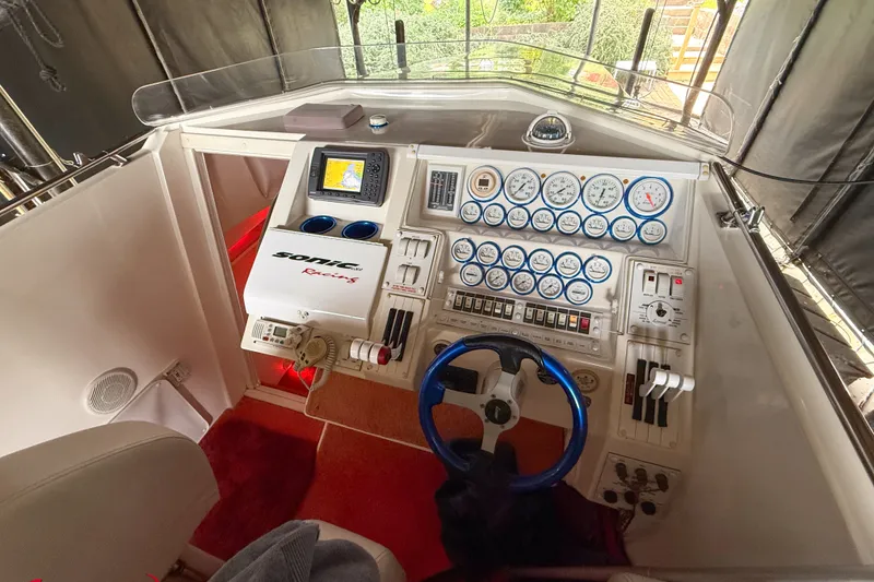 Slide: The Image of Cockpit of a 2000 Sonic 45 SS boat with gauges and steering wheel. - 40