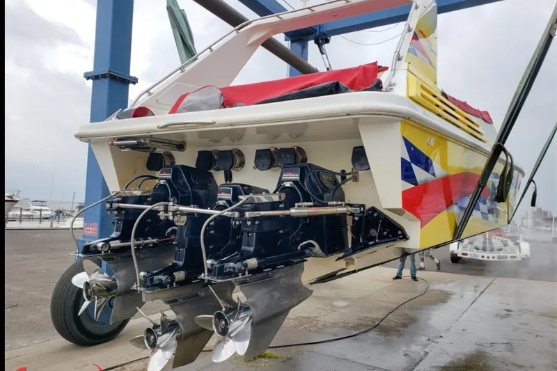Slide: The Image of Rear view of a 2000 Sonic 45 SS boat with colorful graphics and dual outboard motors. - 10
