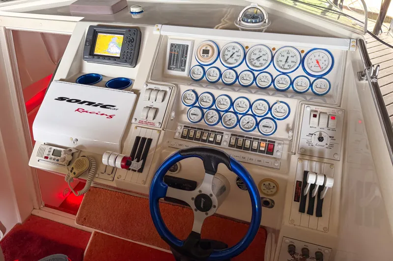 Slide: The Image of Control panel of a 2000 Sonic 45 SS boat with gauges and steering wheel. - 39