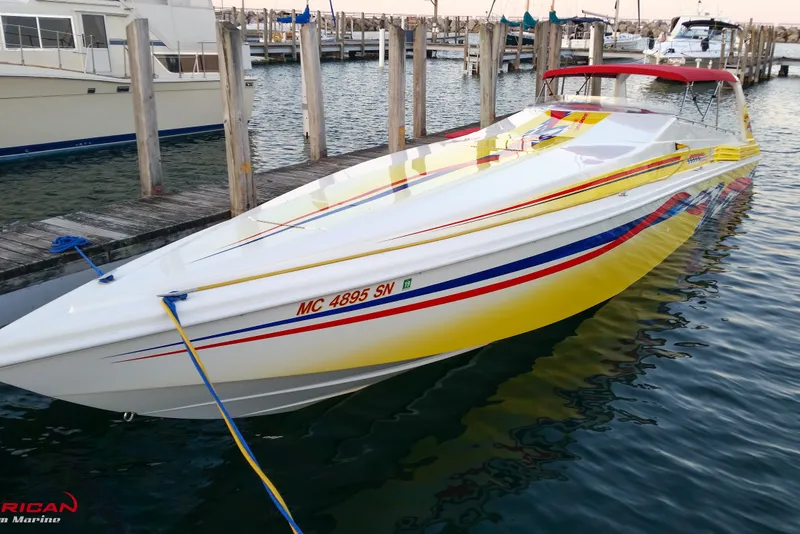 Slide: The Image of 2000 Sonic 45 SS speedboat docked, featuring vibrant yellow and red accents. - 1