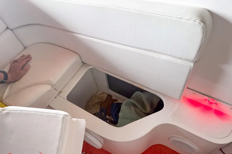 Slide: The Image of White interior storage compartment in a 2000 Sonic 45 SS boat. - 46