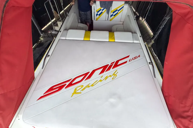 Slide: The Image of 2000 Sonic 45 SS boat interior with branded upholstery and vibrant red accents. - 43
