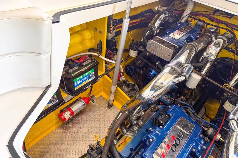 Slide: The Image of Engine compartment of a 2000 Sonic 45 SS boat with visible batteries and fire extinguisher. - 28