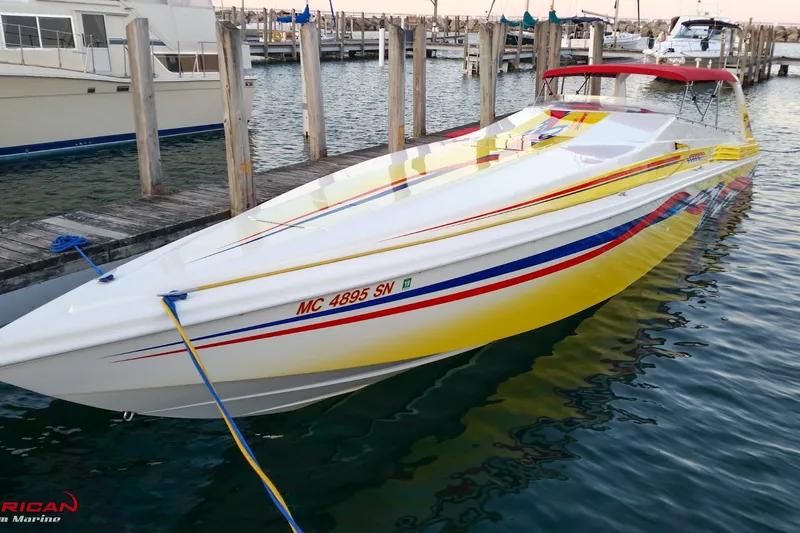 Slide: The Image of 2000 Sonic 45 SS speedboat docked, featuring vibrant yellow and red accents. - 3