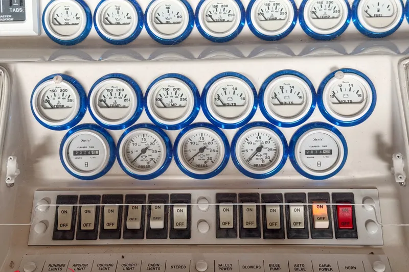 Slide: The Image of Control panel of a 2000 Sonic 45 SS boat with gauges and switches. - 47
