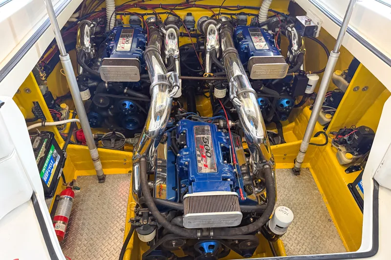 Slide: The Image of Engine compartment of a 2000 Sonic 45 SS boat, featuring dual high-performance engines. - 27