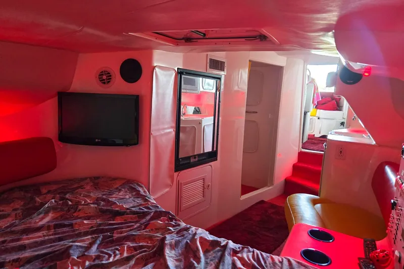 Slide: The Image of Interior of 2000 Sonic 45 SS boat with red lighting and modern amenities. - 9