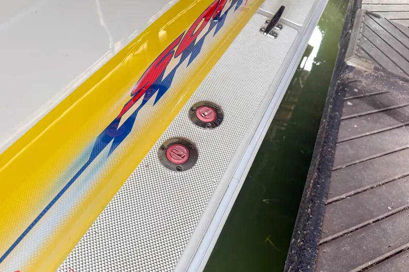 Slide: The Image of Close-up of 2000 Sonic 45 SS boat with vibrant graphics and fuel caps. - 45