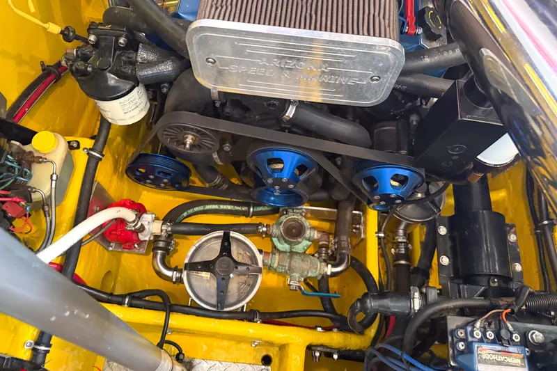 Slide: The Image of Engine compartment of a 2000 Sonic 45 SS boat, featuring detailed mechanical components. - 32