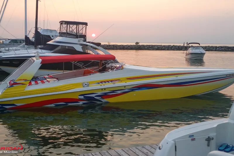 Slide: The Image of Vibrant 2000 Sonic 45 SS speedboat docked at sunset, featuring colorful graphics. - 2