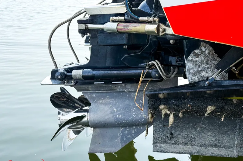 Slide: The Image of Outboard motor of a 2000 Sonic 45 SS boat with visible propeller in water. - 14