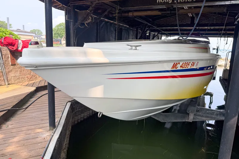 Slide: The Image of 2000 Sonic 45 SS boat docked, featuring sleek white hull with red and blue accents. - 11