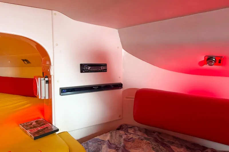 Slide: The Image of Interior of a 2000 Sonic 45 SS boat with red lighting and entertainment system. - 22