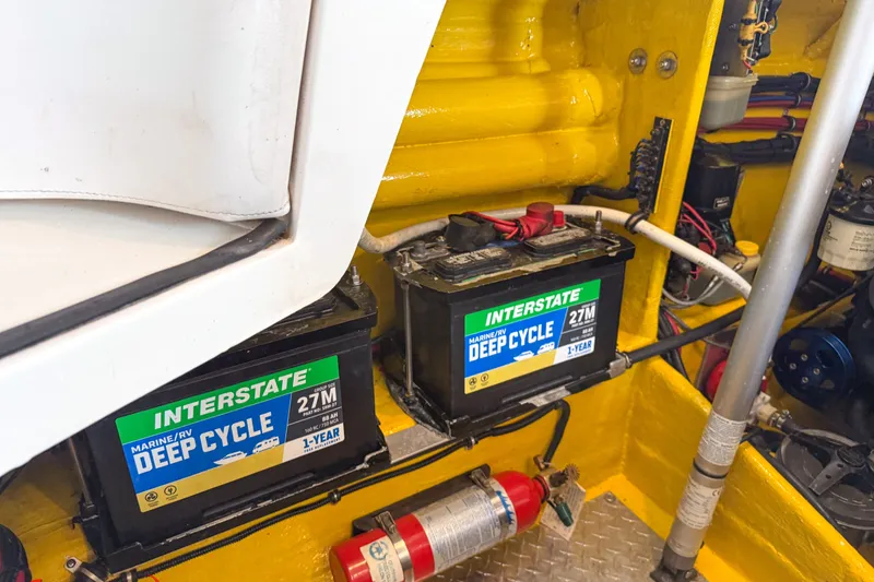 Slide: The Image of Marine batteries and fire extinguisher in a 2000 Sonic 45 SS boat engine compartment. - 31